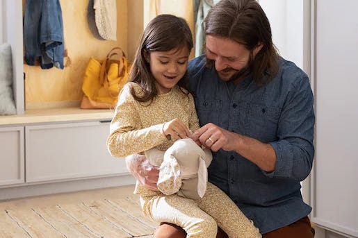 Father and daughter hanging out in the laundry room